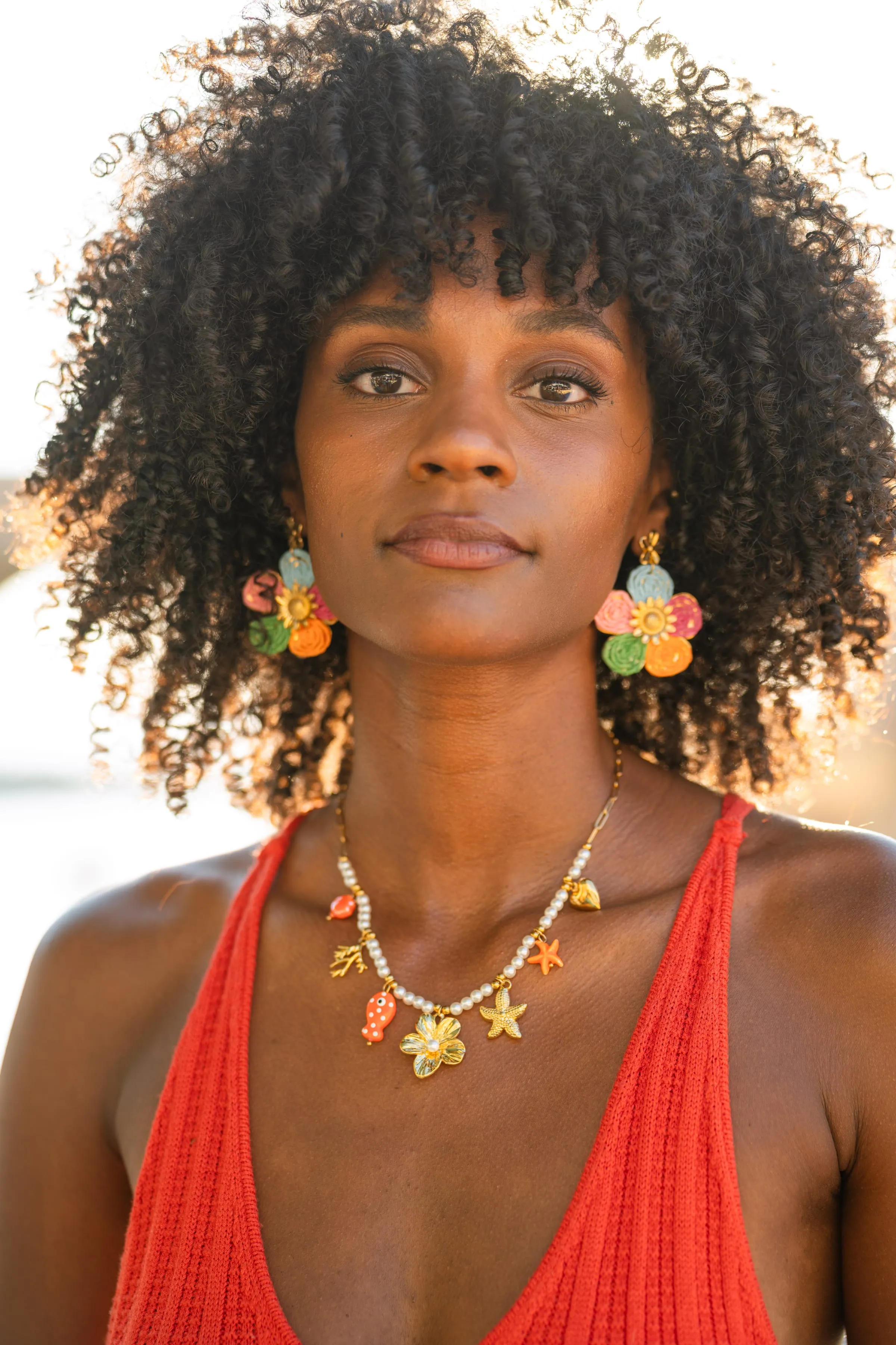 Portrait éditorial d'une femme portant des bijoux dorés Mary Jane, regard face caméra